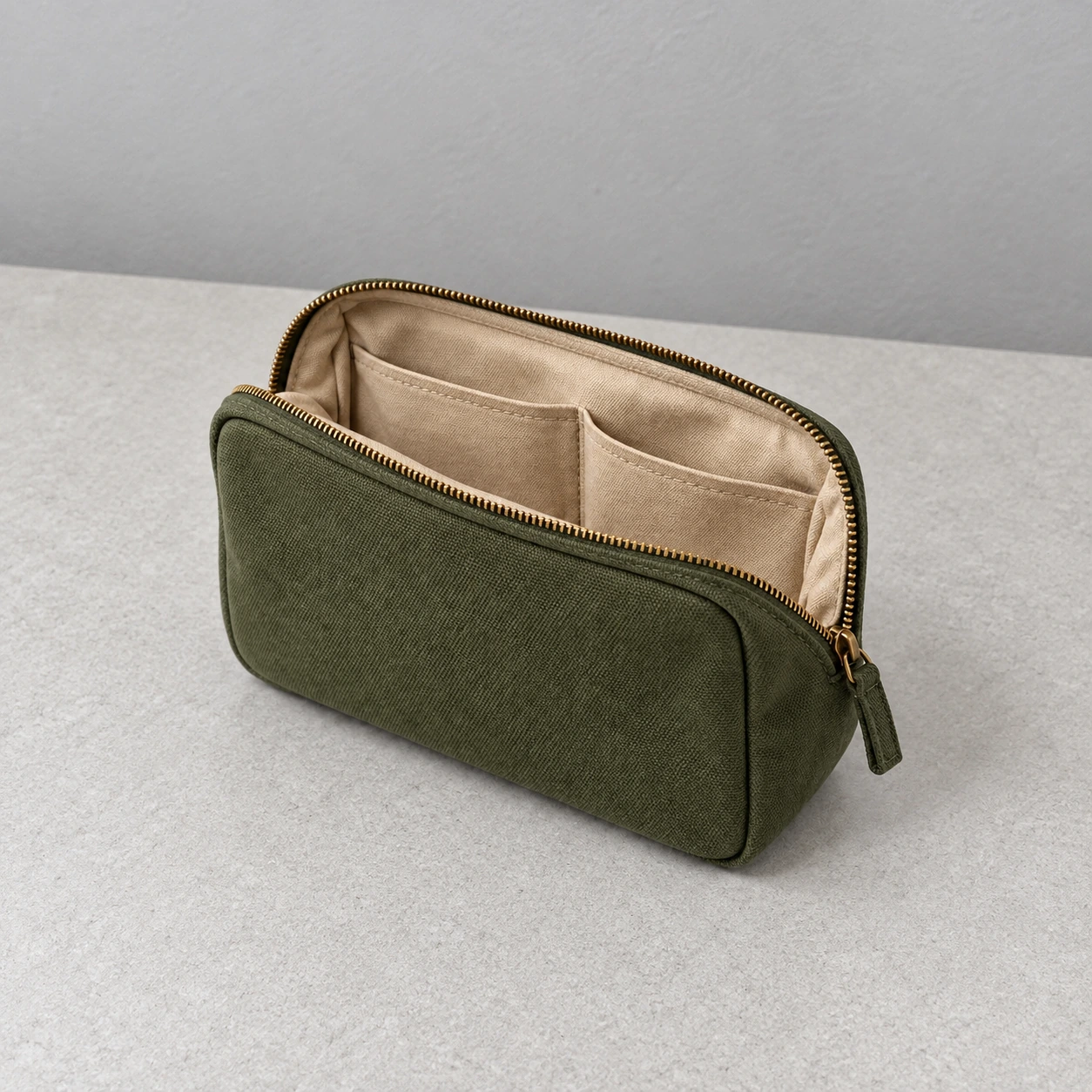 Constructed baseline: an olive canvas pouch photographed simply on a grey tabletop